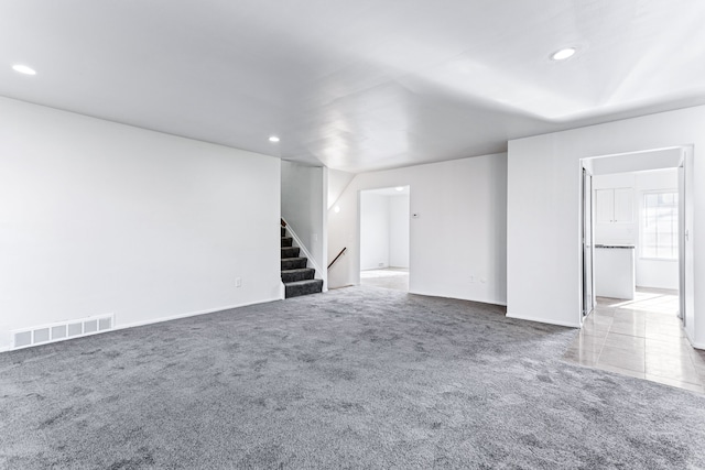 unfurnished living room featuring carpet