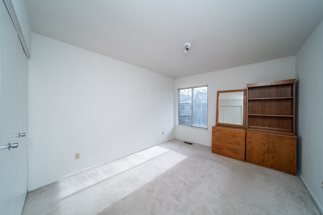 unfurnished bedroom featuring light colored carpet