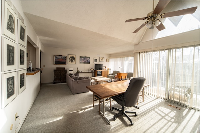 dining room featuring carpet flooring, a textured ceiling, ceiling fan, and lofted ceiling