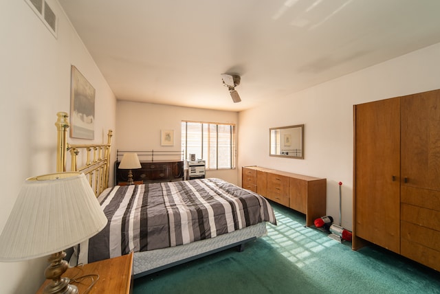 bedroom with dark colored carpet, a closet, and ceiling fan