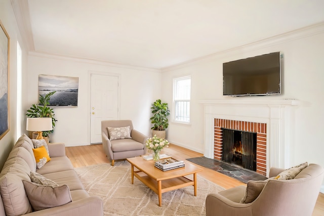 living room featuring a fireplace, light hardwood / wood-style floors, and ornamental molding