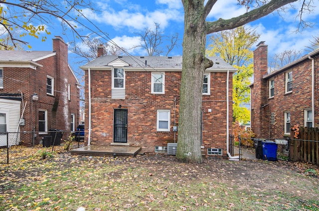 rear view of property featuring central AC