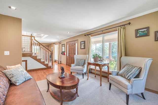 living room with light hardwood / wood-style flooring and crown molding