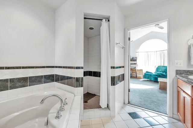 bathroom with tile patterned floors, vanity, vaulted ceiling, and independent shower and bath