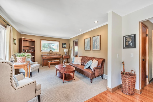 living room with light hardwood / wood-style floors and ornamental molding