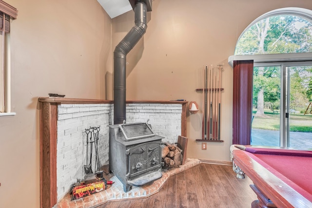 interior space featuring wood-type flooring and a wood stove