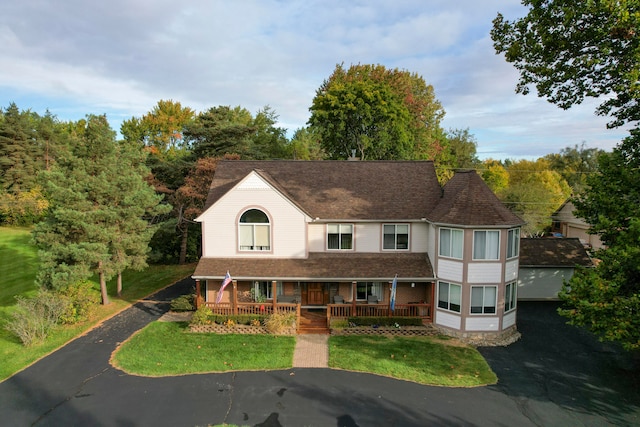 view of front of property with a front yard and a porch