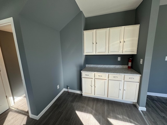 kitchen featuring white cabinetry and dark wood-type flooring