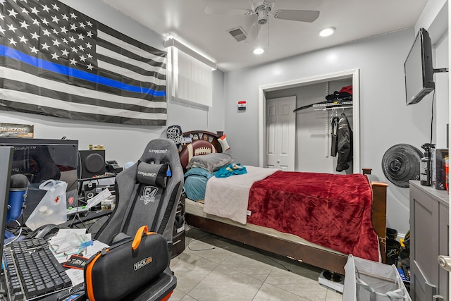 bedroom featuring ceiling fan, a closet, and light tile patterned flooring