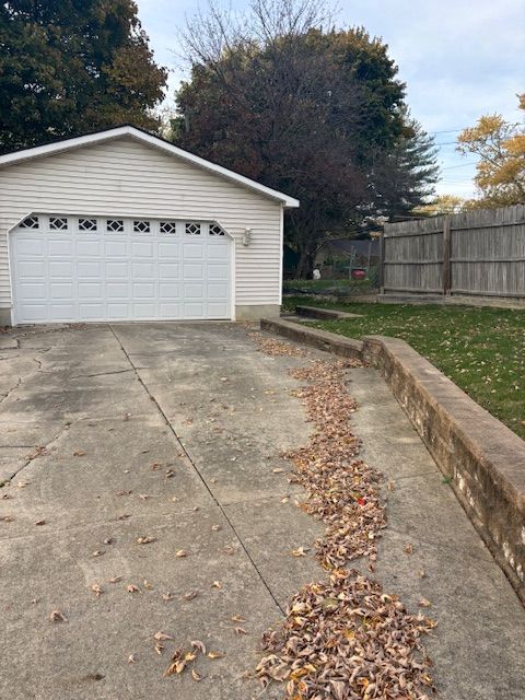 detached garage featuring fence