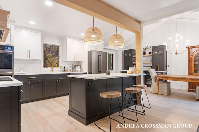 4719 Fox Hill Ln, Macatawa, MI 49434 - kitchen with appliances with stainless steel finishes, white cabinets, light wood-type flooring, tasteful backsplash, and recessed lighting