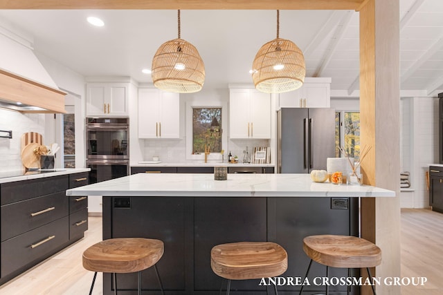 4719 Fox Hill Ln, Macatawa, MI 49434 - kitchen featuring appliances with stainless steel finishes, white cabinets, backsplash, a breakfast bar, and recessed lighting
