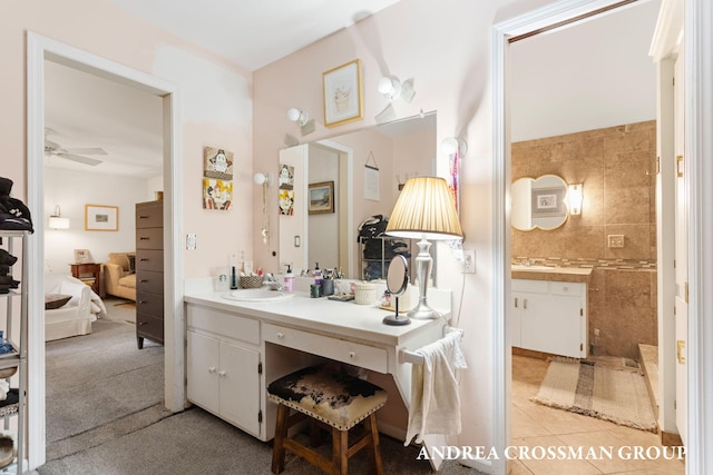 4719 Fox Hill Ln, Macatawa, MI 49434 - ensuite bathroom featuring vanity, tile patterned floors, ceiling fan, and a tile shower