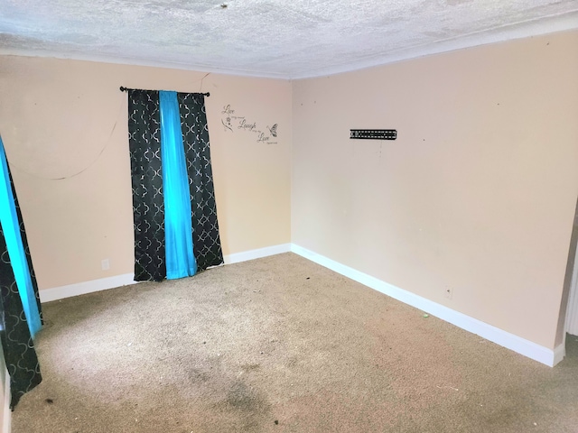 carpeted spare room featuring a textured ceiling