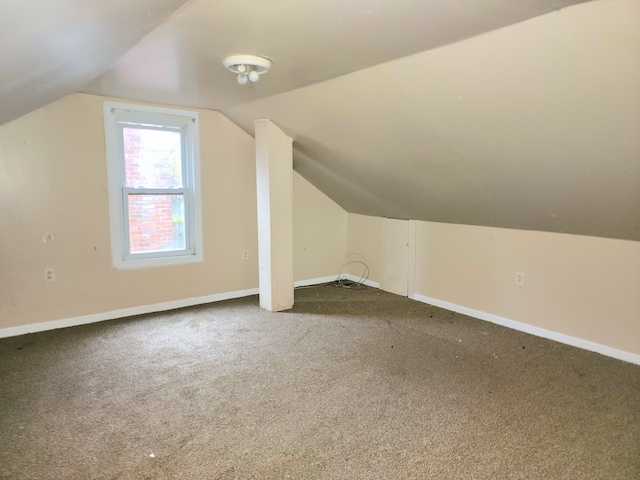 bonus room with carpet flooring and lofted ceiling