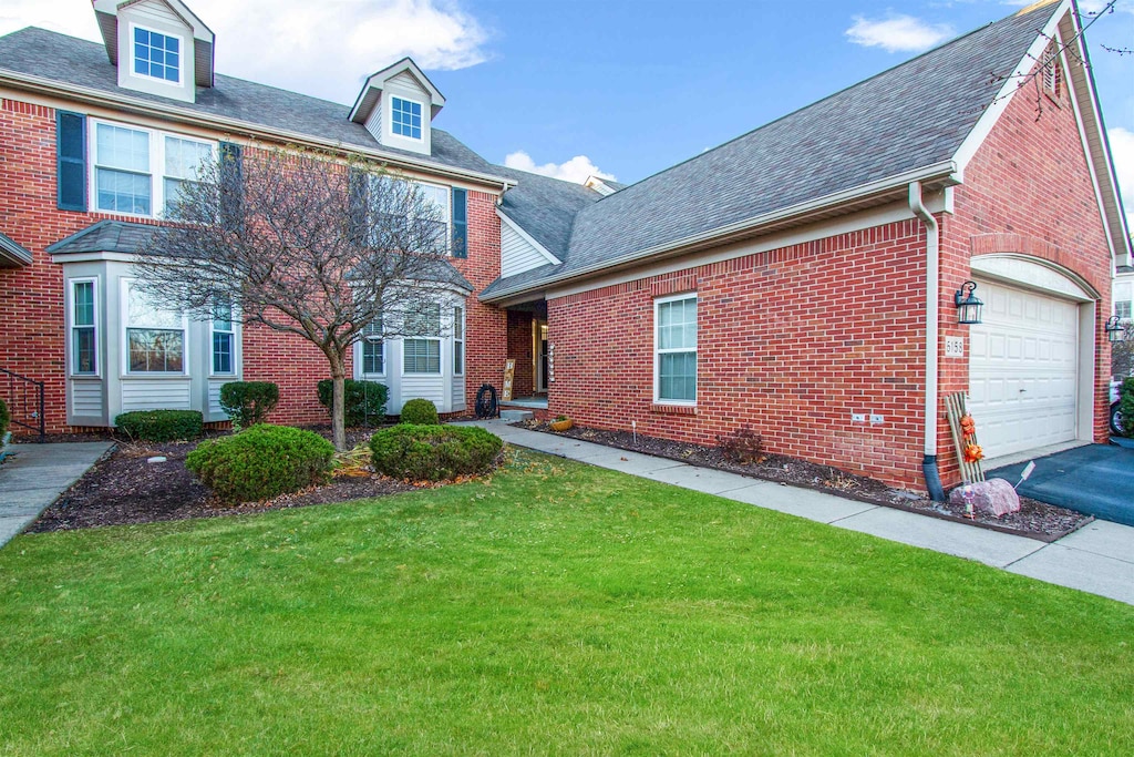 view of front of property featuring a garage and a front lawn