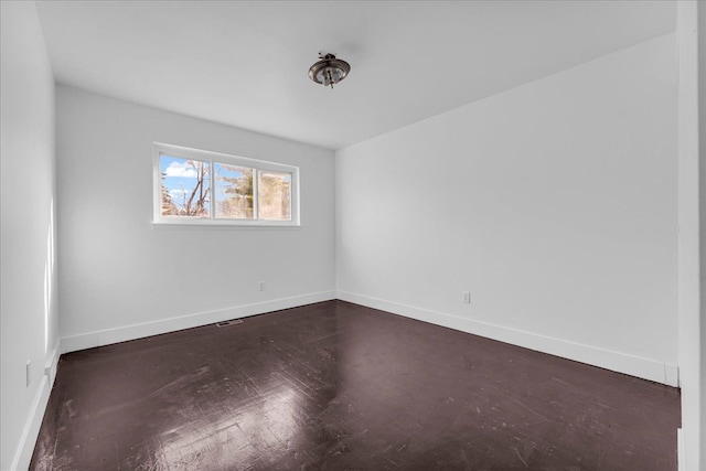 empty room featuring dark hardwood / wood-style flooring