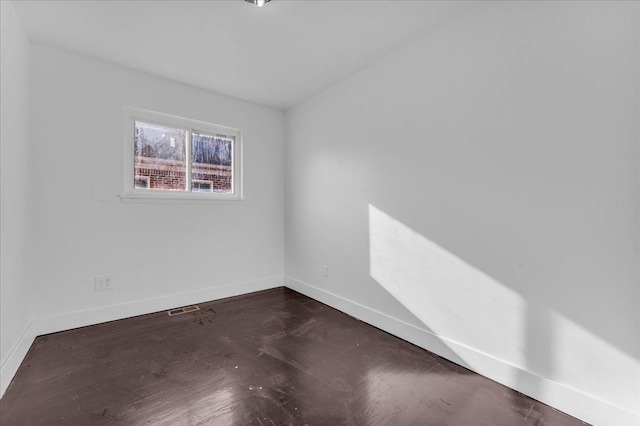 spare room featuring dark hardwood / wood-style flooring