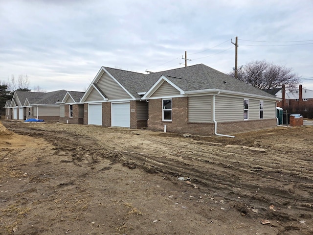 18750 14 Mile Rd, Roseville, MI 48066 - view of front facade with driveway, brick siding, a garage, and roof with shingles