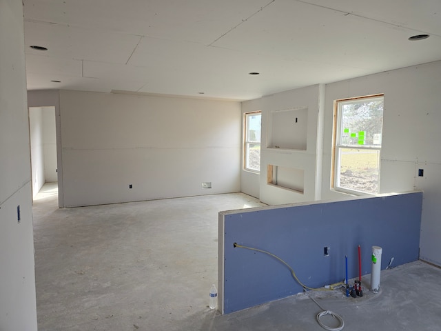 18750 14 Mile Rd, Roseville, MI 48066 - spare room featuring plenty of natural light and unfinished concrete flooring