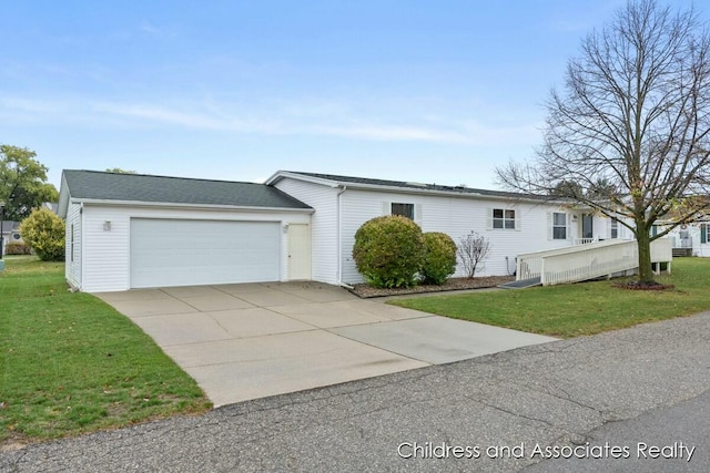 view of front of property with a garage and a front lawn