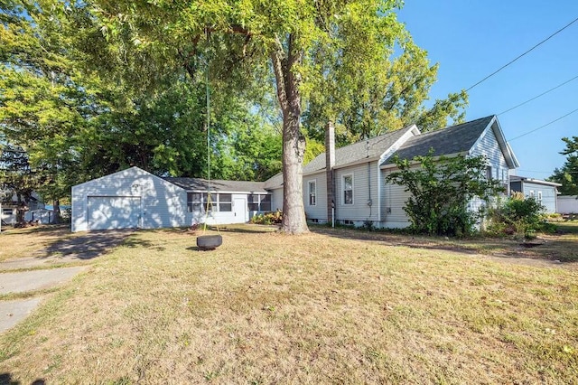 view of front facade with a front yard and a garage