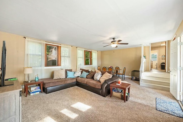 living room with light colored carpet, a wealth of natural light, and ceiling fan