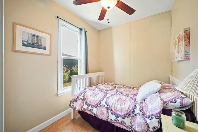 bedroom with ceiling fan and wood-type flooring