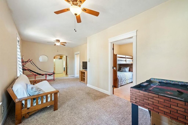 living area with light colored carpet, plenty of natural light, and ceiling fan