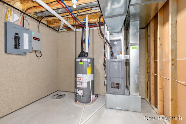 utility room featuring electric panel, heating unit, and gas water heater