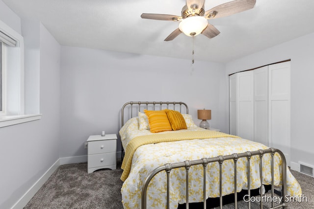 bedroom with dark colored carpet, a closet, and ceiling fan