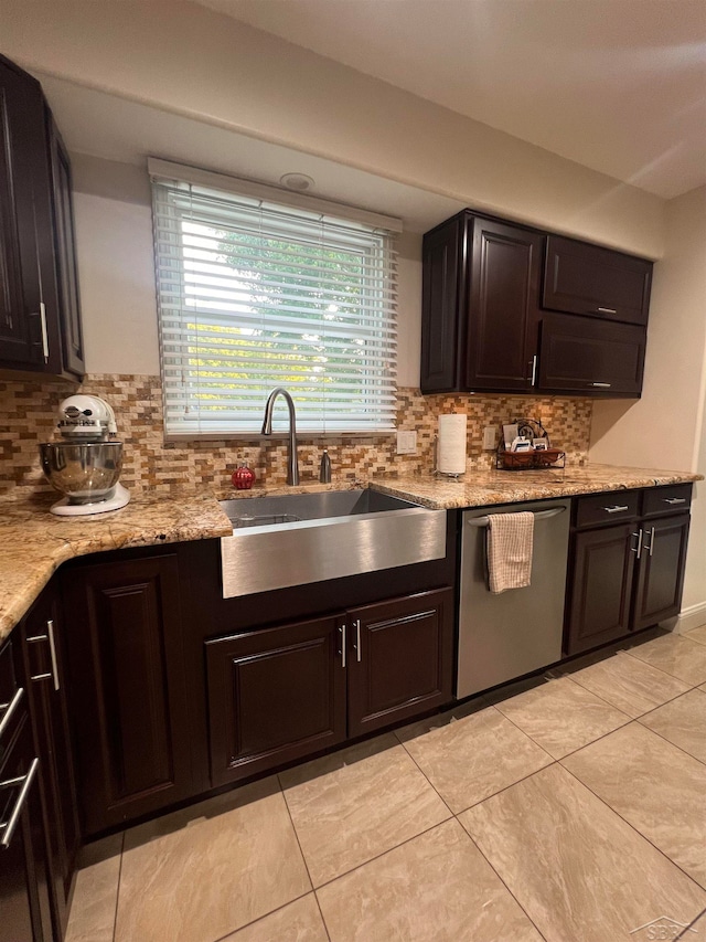 kitchen featuring dishwasher, dark brown cabinetry, and sink