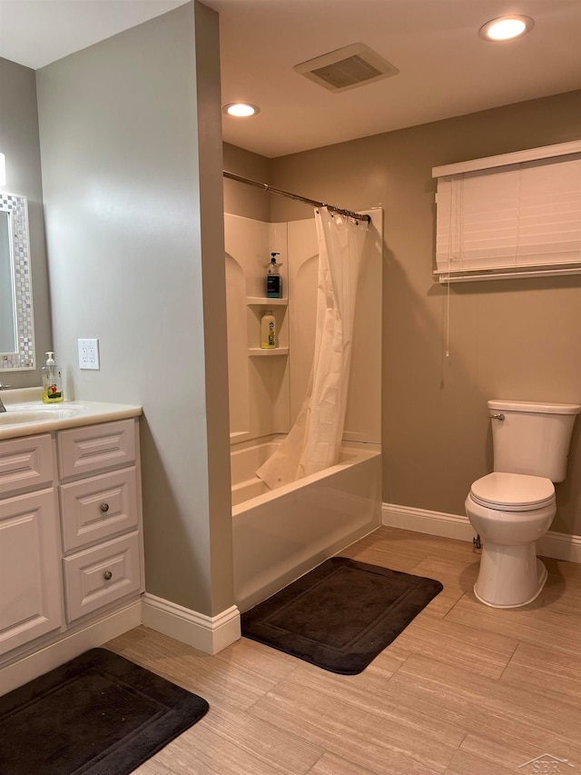 full bathroom with shower / bath combo with shower curtain, vanity, and toilet