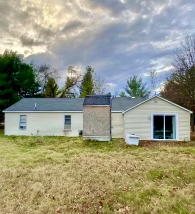 back of house featuring a lawn