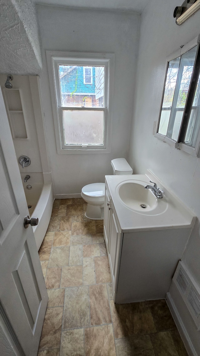 full bathroom with a wealth of natural light, vanity,  shower combination, and toilet