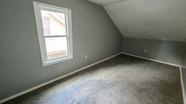 bonus room with carpet and lofted ceiling