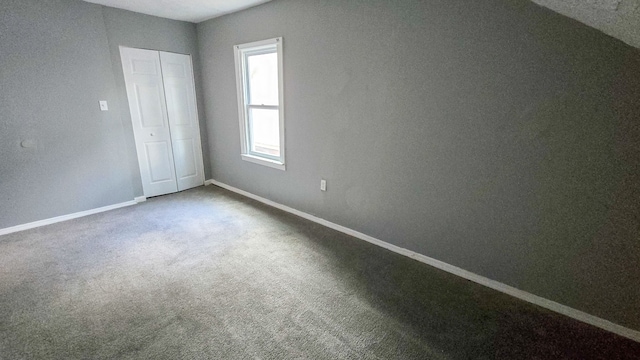 unfurnished bedroom with carpet and a closet