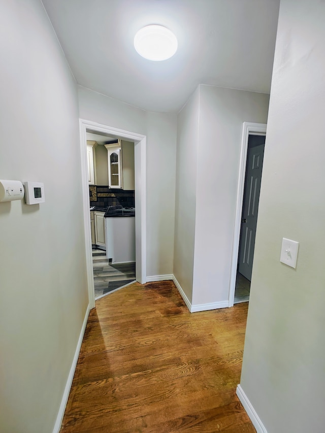 hall with hardwood / wood-style floors