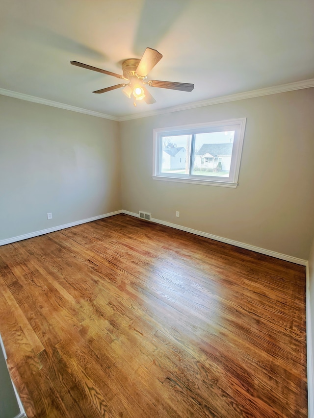 unfurnished room featuring hardwood / wood-style floors, ceiling fan, and ornamental molding