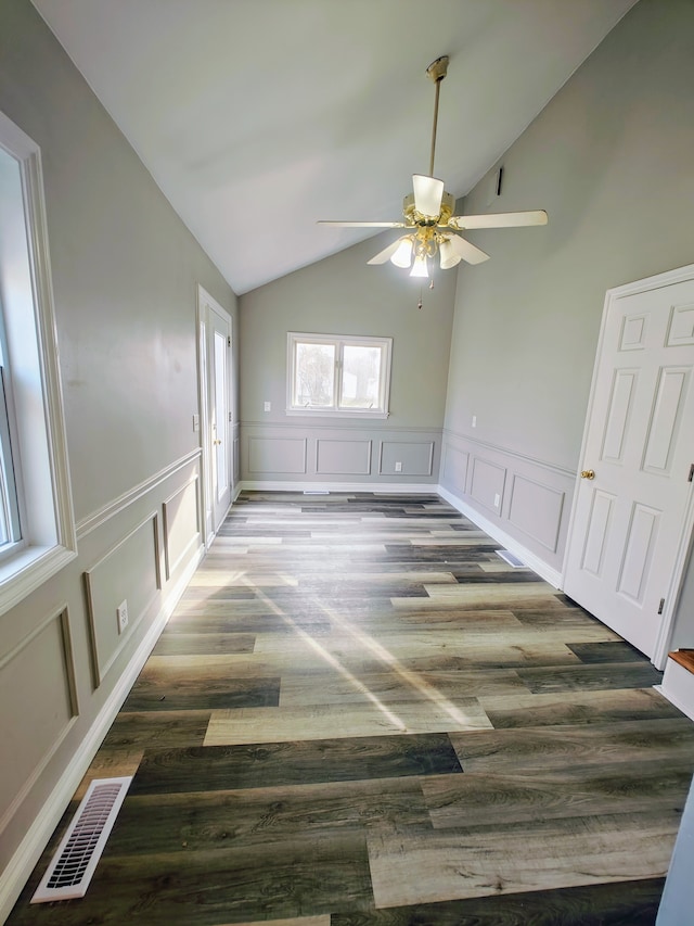 unfurnished room with ceiling fan, dark hardwood / wood-style flooring, and vaulted ceiling