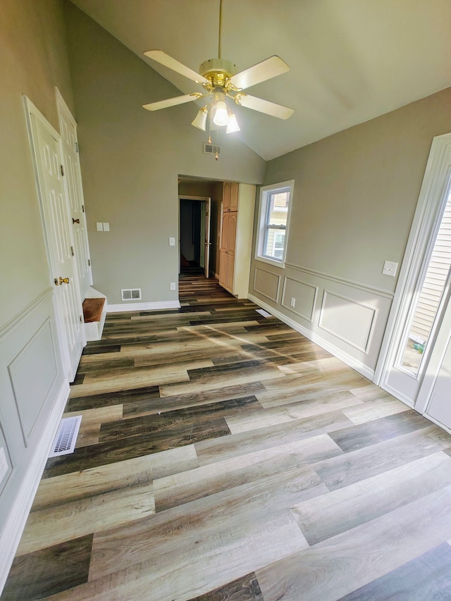 empty room featuring ceiling fan, wood-type flooring, and vaulted ceiling