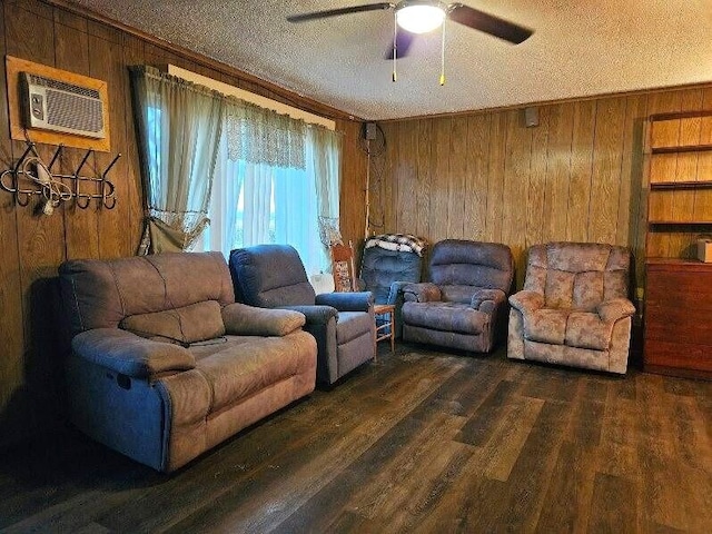 living room featuring a wall mounted air conditioner, wooden walls, ceiling fan, a textured ceiling, and dark hardwood / wood-style flooring