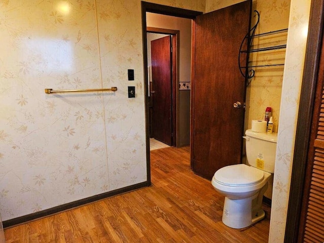 bathroom featuring wood-type flooring and toilet