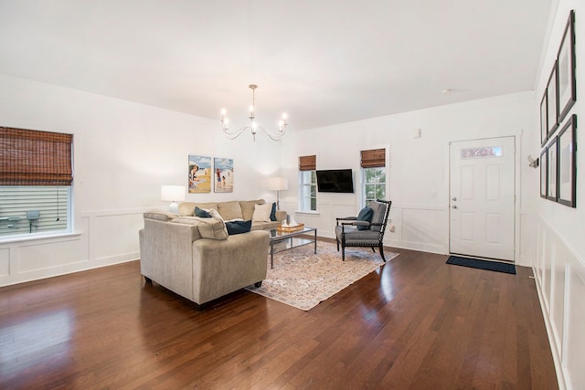 living room featuring dark hardwood / wood-style floors and a notable chandelier