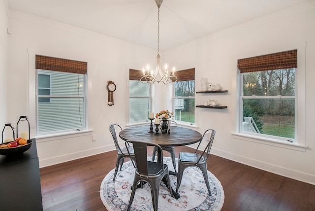 dining space with crown molding, plenty of natural light, a chandelier, and dark hardwood / wood-style floors