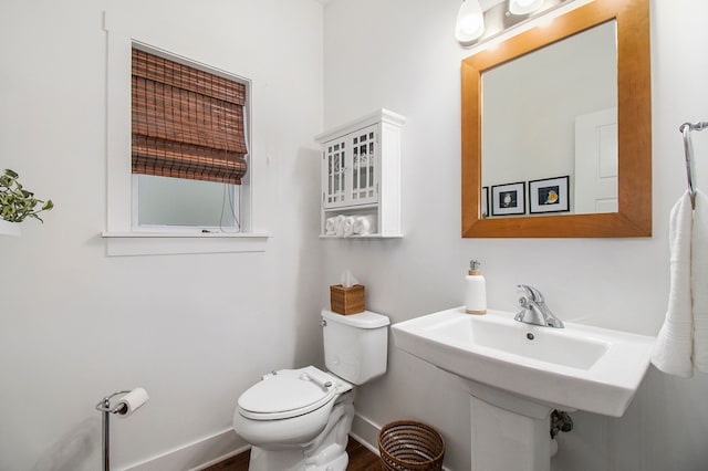 bathroom featuring hardwood / wood-style flooring and toilet