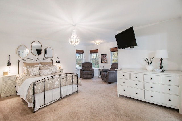 carpeted bedroom with an inviting chandelier