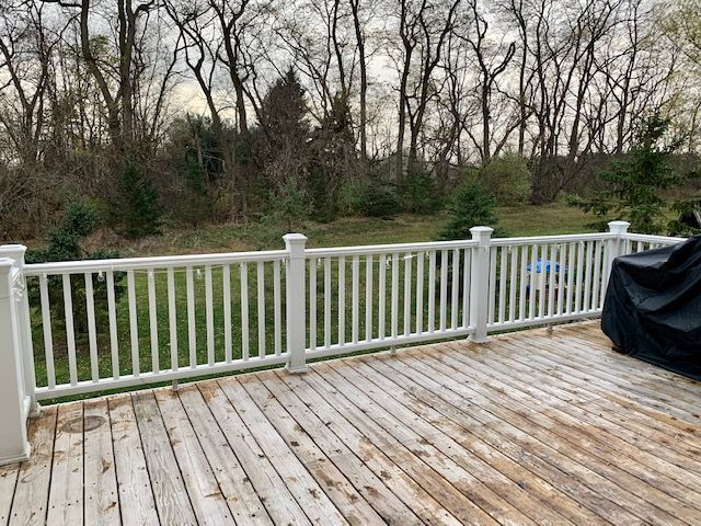 wooden terrace with a lawn