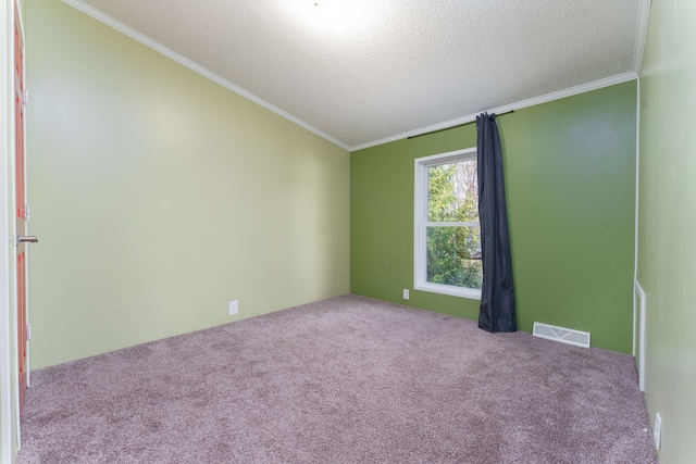 empty room with light carpet, crown molding, and a textured ceiling