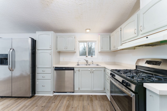 kitchen featuring white cabinets, stainless steel appliances, and exhaust hood